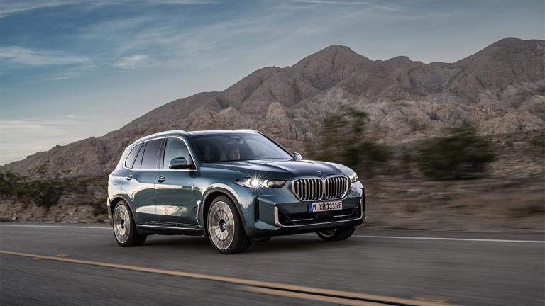 2025 BMW X5 driving on the road.